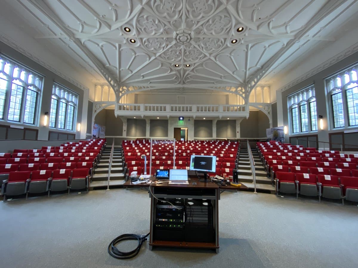 Auditorium at the Catholic University of America with tiered seating and large presentation screens
